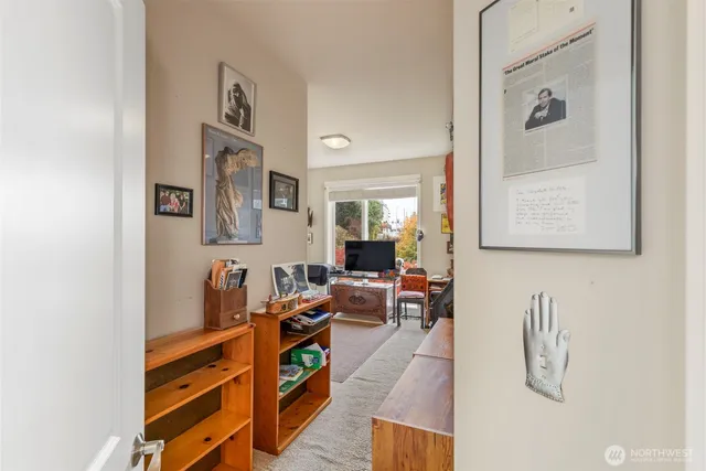 a living room with furniture and paintings on the wall