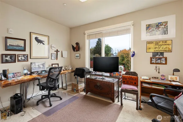 a view of a workspace with a window and lounge chair