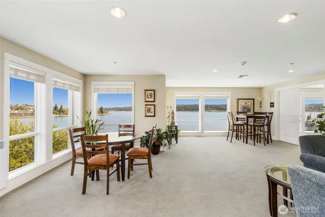 a dining room with furniture and natural light