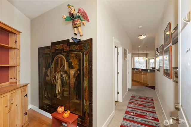 a view of a hallway and a livingroom with furniture