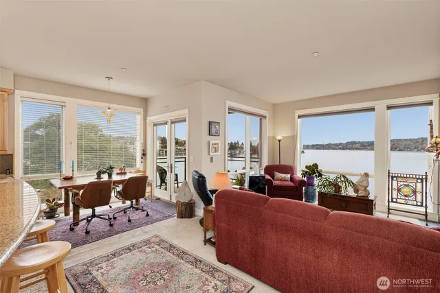 a living room with furniture and large windows