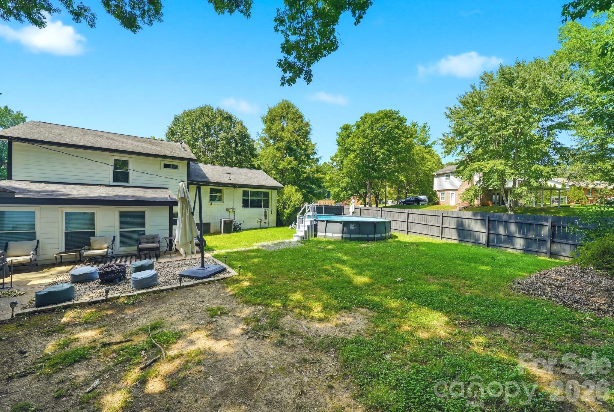 7552 Idlewild Road Charlotte, NC 28212 - Photo 26 of 40 a view of a house with backyard porch and furniture