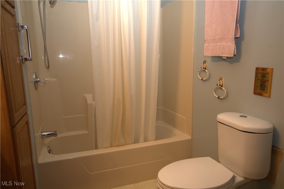 22760 Roy Croy Road Senecaville, OH 43780 - Photo 18 of 46 Bathroom with shower / bath combination with curtain and tile patterned floors