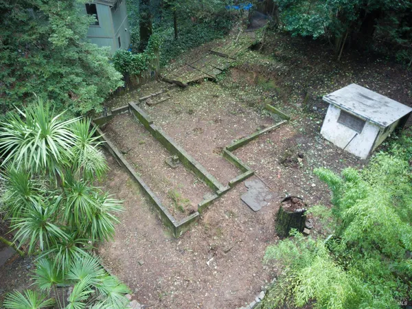 an aerial view of a house with a yard
