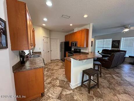 159 Old Starke Road Palatka, FL 32177 - Photo 12 of 13 a large kitchen with kitchen island granite countertop a sink and a counter top space