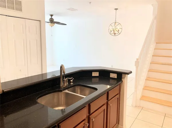 a kitchen with stainless steel appliances granite countertop a refrigerator a stove a sink and a microwave