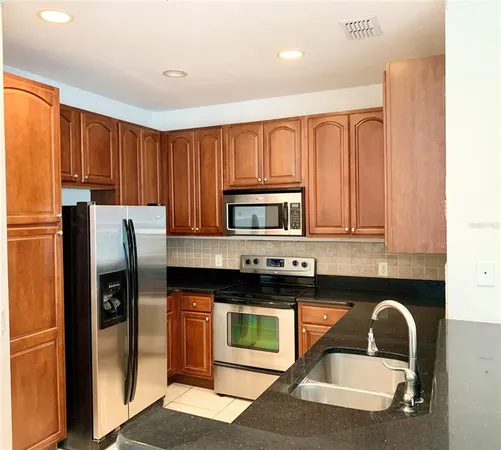a stove top oven sitting inside of a kitchen