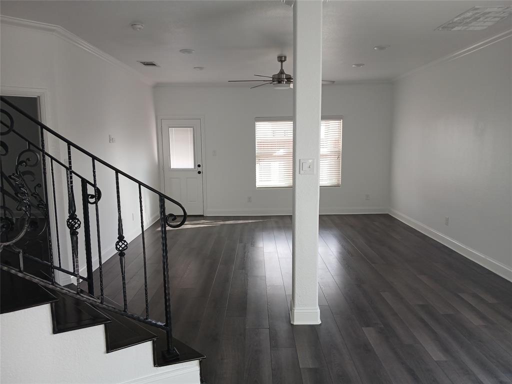 8045 Ballater Drive Fort Worth, TX 76123 - Photo 11 of 26 Unfurnished living room featuring crown molding, stairway, ceiling fan, and dark wood-type flooring