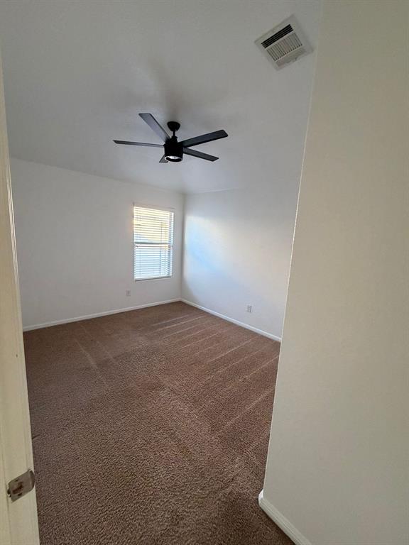 8045 Ballater Drive Fort Worth, TX 76123 - Photo 21 of 26 Spare room featuring dark colored carpet and a ceiling fan