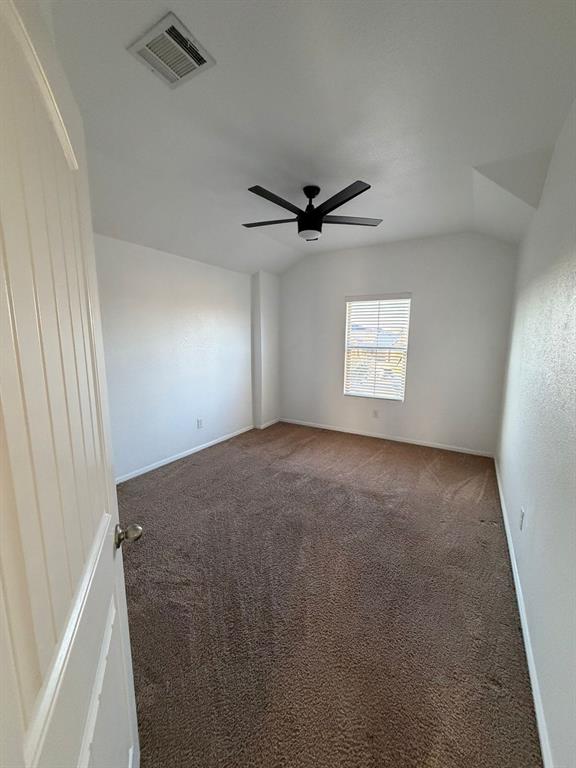 8045 Ballater Drive Fort Worth, TX 76123 - Photo 23 of 26 Carpeted empty room featuring lofted ceiling and ceiling fan