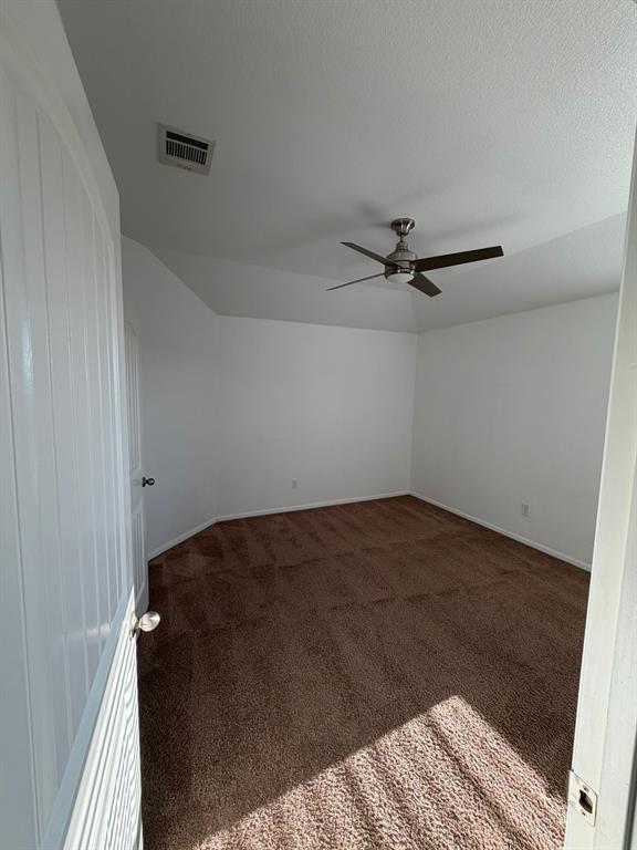 8045 Ballater Drive Fort Worth, TX 76123 - Photo 24 of 26 Carpeted empty room featuring a textured ceiling and a ceiling fan