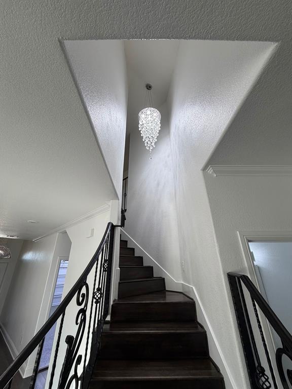 8045 Ballater Drive Fort Worth, TX 76123 - Photo 10 of 26 Staircase with a chandelier and a textured ceiling