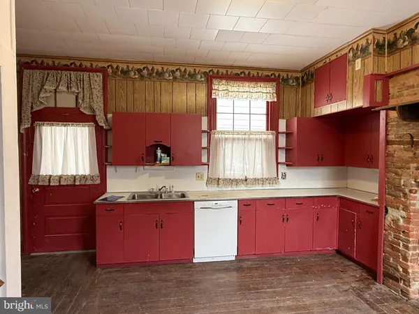 a kitchen with a sink cabinets and window