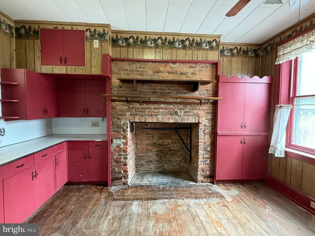 a kitchen with stainless steel appliances granite countertop a stove top oven a sink and a microwave