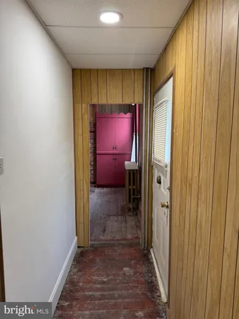 a view of a hallway with wooden shelves