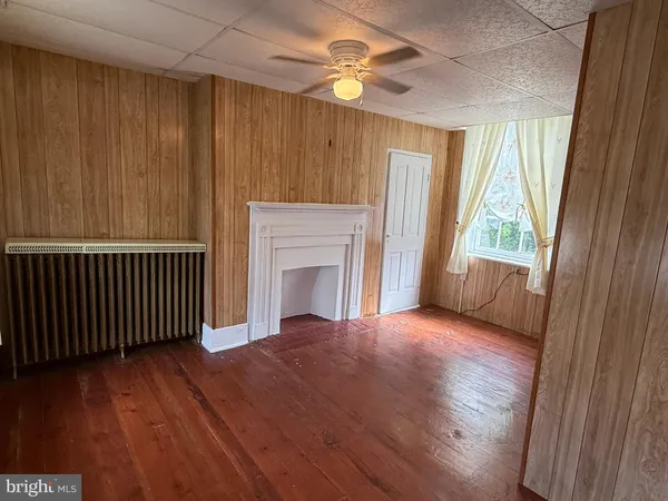 wooden floor in an empty room with a window