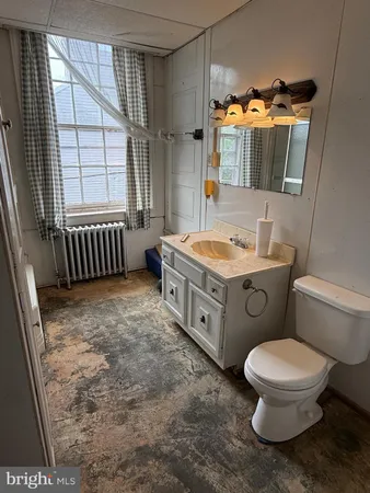 a bathroom with a tub and a window