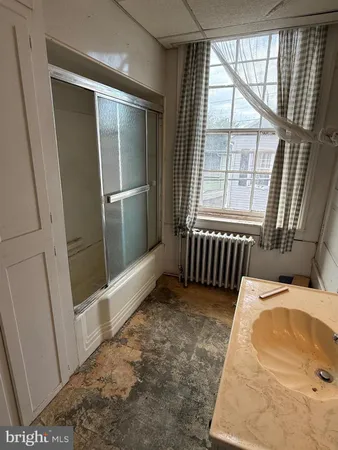a view of empty room with wooden floor and fireplace