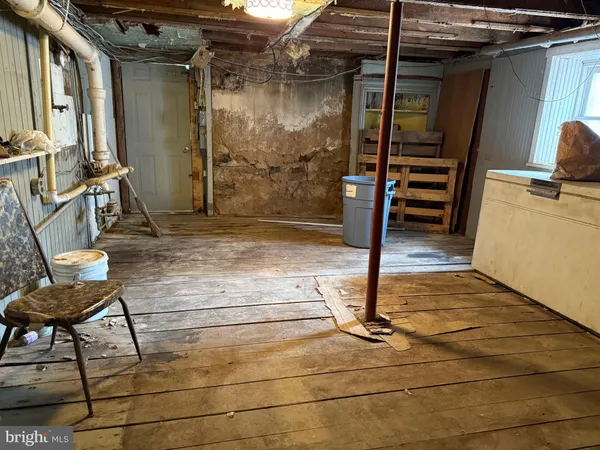 a room with a mirror and a wooden floor
