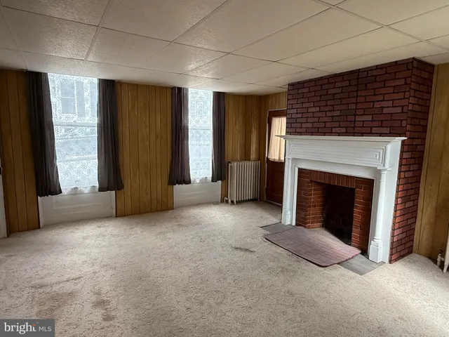 a view of an empty room with a fireplace