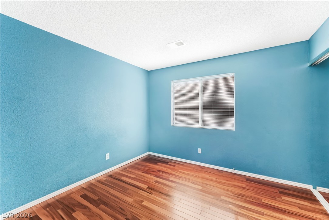 1402 Rim Fire Circle Henderson, NV 89014 - Photo 34 of 48 Gleaming wood floors run throughout this versatile space anchored by a central window.