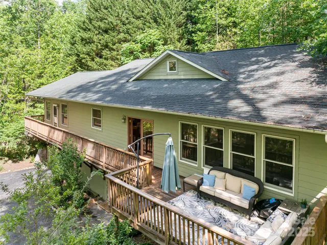 a front view of a house with glass windows and a table
