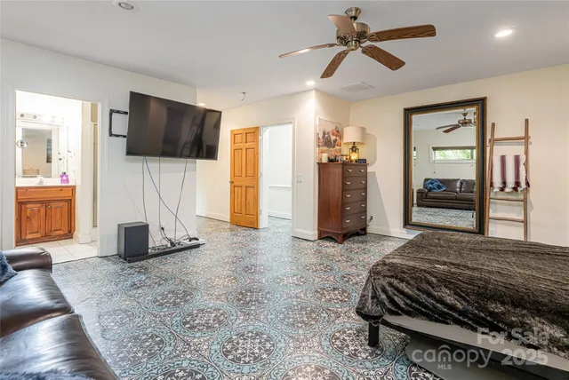 a bedroom with a bed and a television