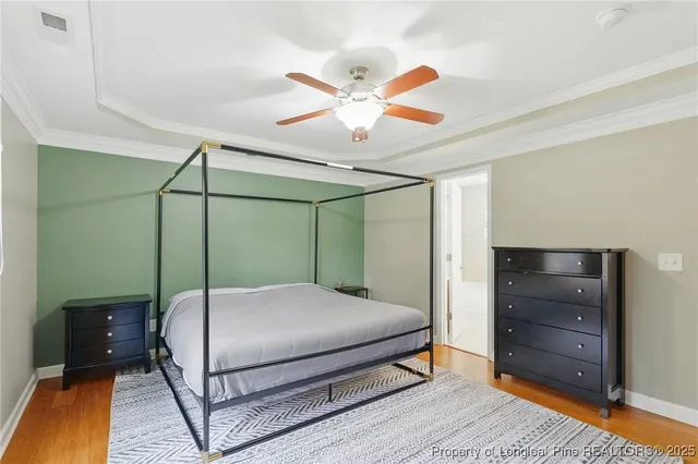 a bedroom with a bed and a ceiling fan
