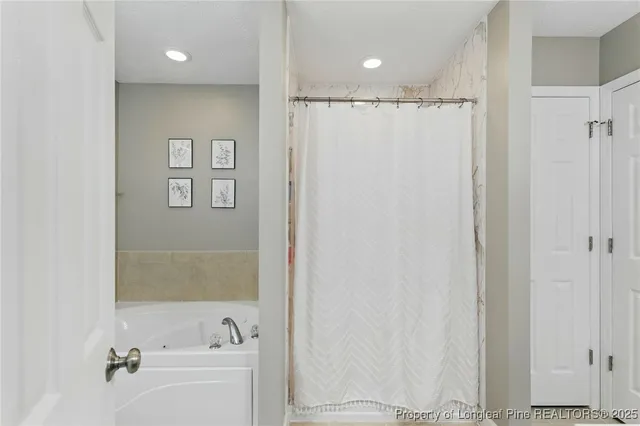 a bathroom with a shower a sink and a toilet