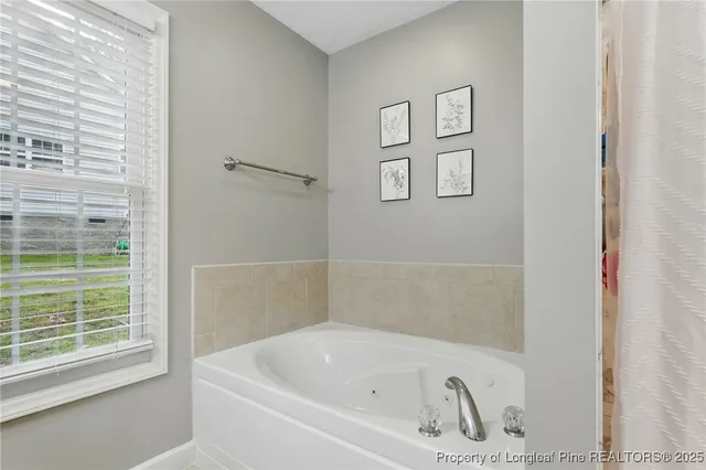 a white bath tub sitting next to a window
