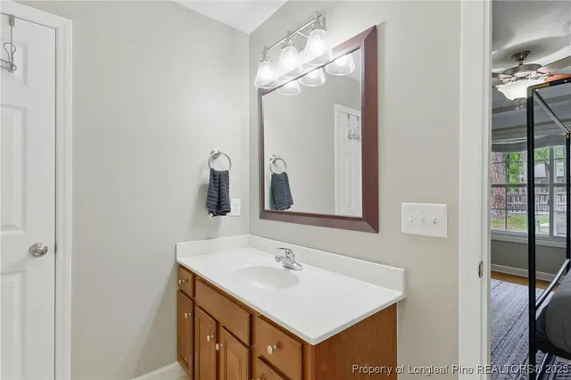 a bathroom with a sink a mirror and a vanity