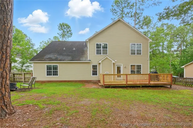 a view of a house with a yard and sitting area