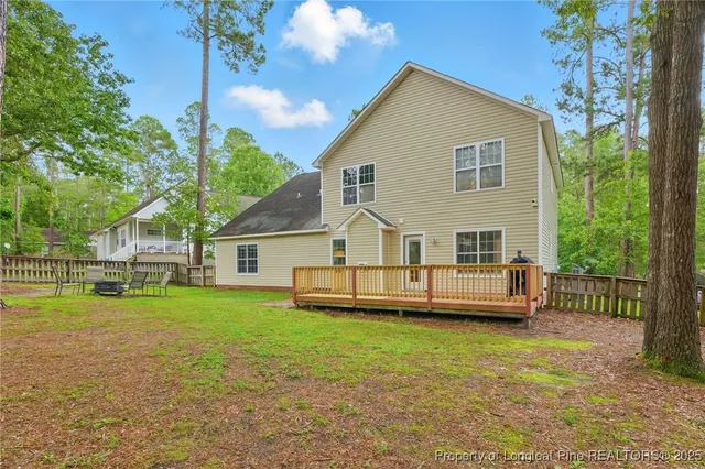 a view of a house with a yard and sitting area