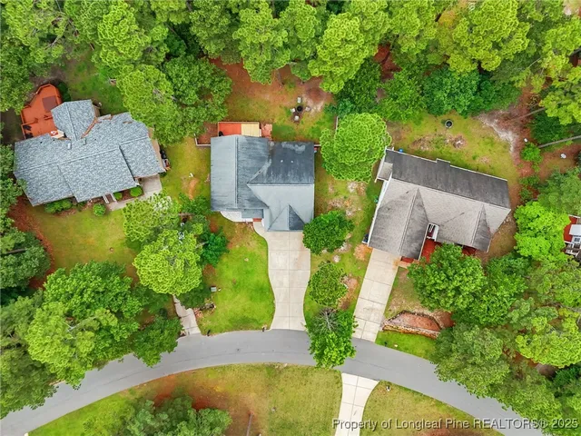 an aerial view of a house with swimming pool and garden