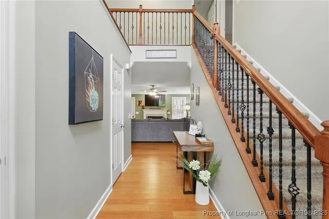 a view of entryway and hall with wooden floor