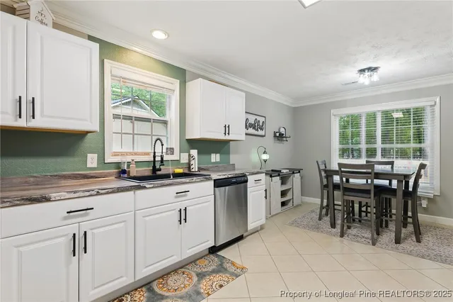 a kitchen with appliances a sink a counter top space and cabinets