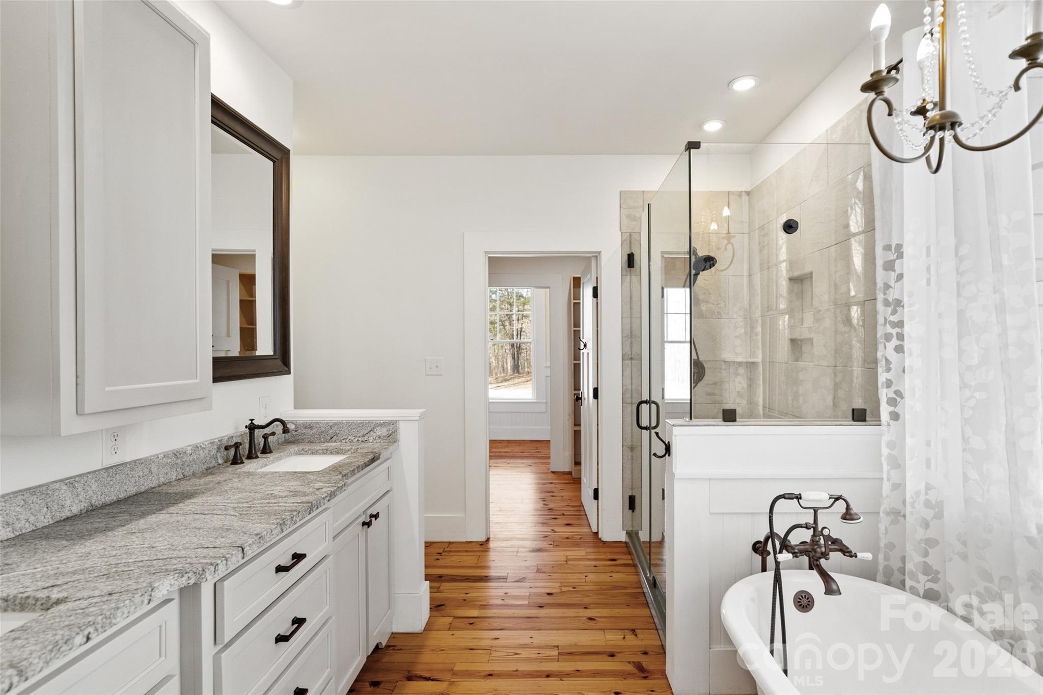 2370 Killian Road Edgemoor, SC 29712 - Photo 13 of 45 a spacious bathroom with a granite countertop sink mirror and a shower
