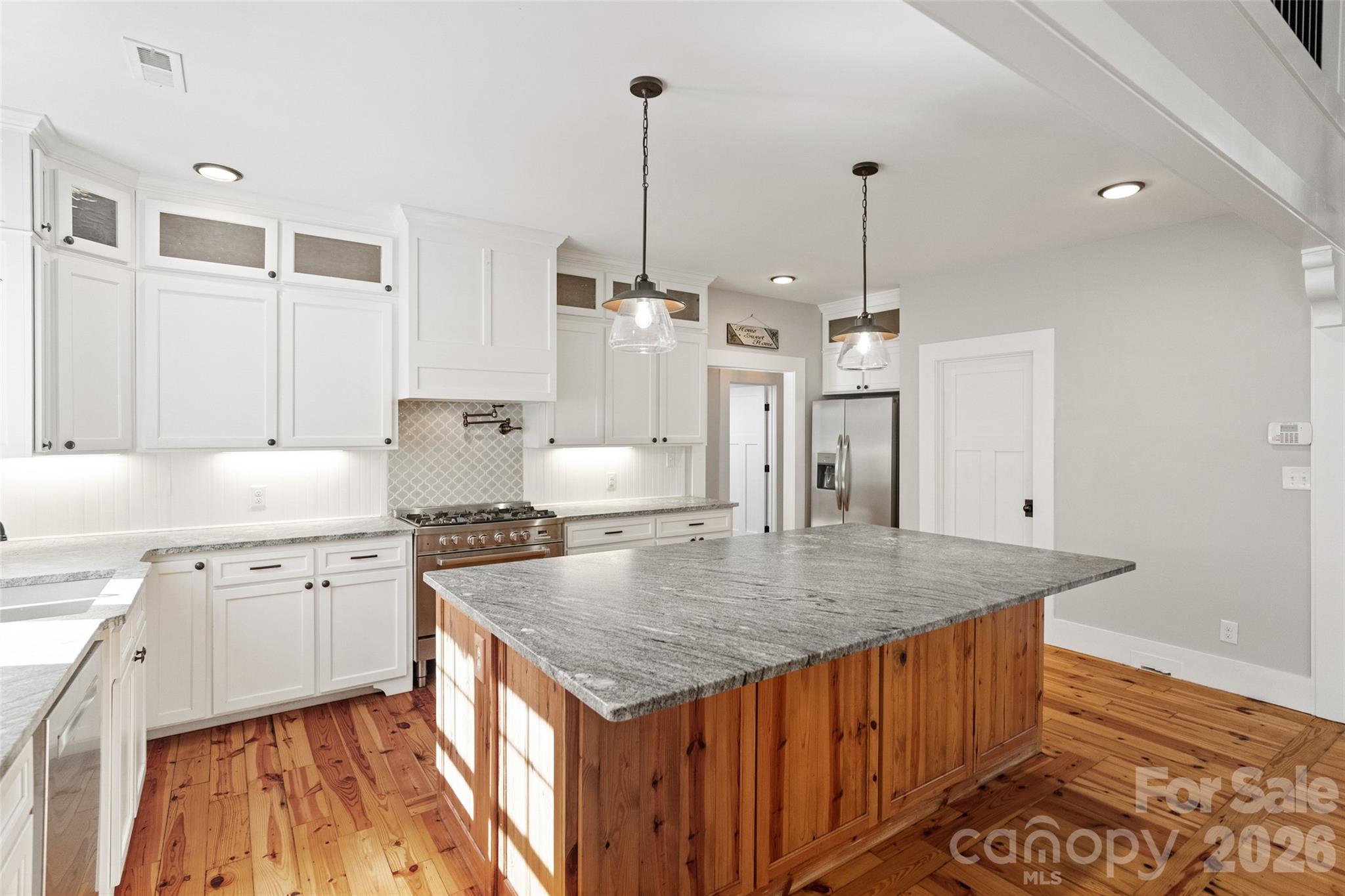 2370 Killian Road Edgemoor, SC 29712 - Photo 10 of 45 a kitchen with stainless steel appliances granite countertop stove top oven and refrigerator