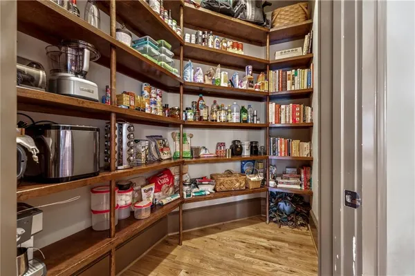 a living room with furniture a fireplace and paintings on the wall