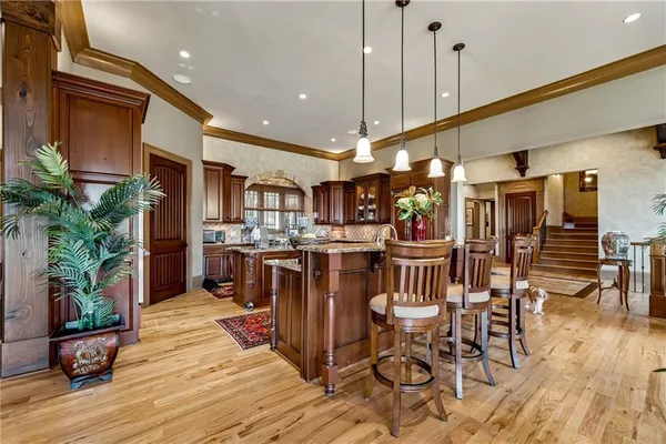 a kitchen with stainless steel appliances granite countertop a refrigerator and a stove top oven