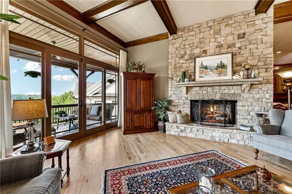 a living room with furniture a potted plant and a fireplace