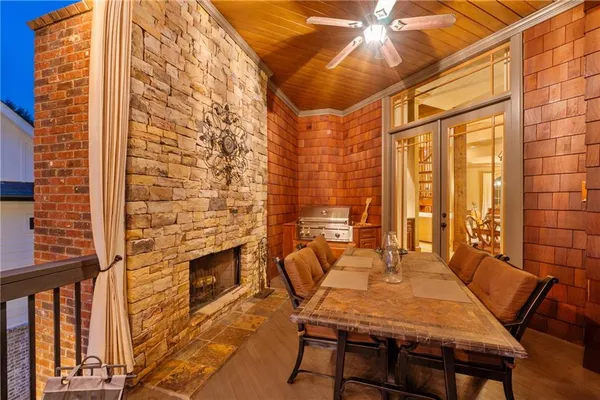 a living room with lots of furniture and a fan