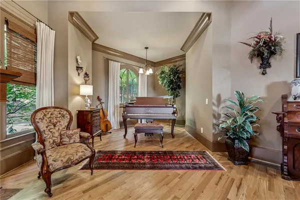 a kitchen with stainless steel appliances kitchen island granite countertop a table chairs and a refrigerator
