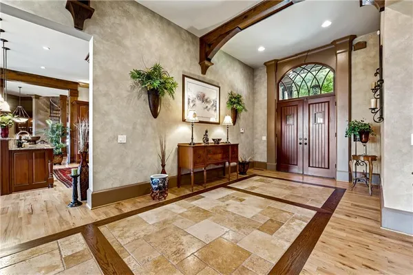 a view of a dining room with furniture large windows and wooden floor