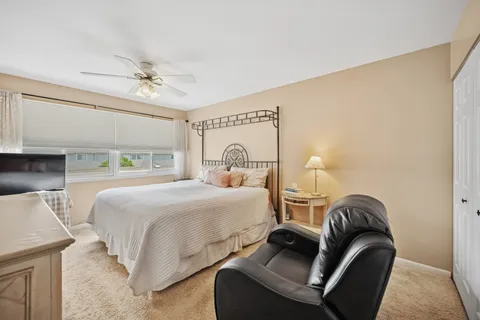 a bedroom with a bed and a mirror