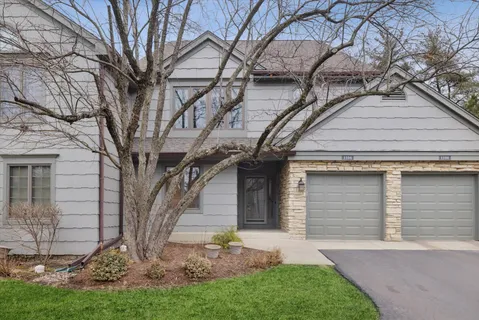 a front view of house with a garden