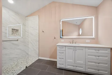 a bathroom with a granite countertop sink a toilet and a mirror
