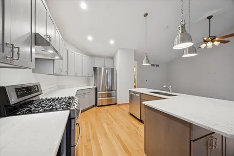 a kitchen that has a lot of cabinets and appliances