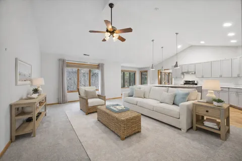 a living room with furniture and a chandelier