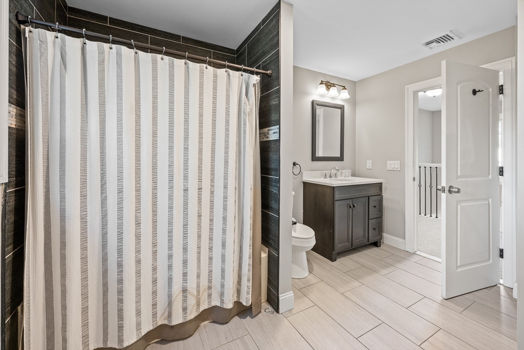 41 Glendale Street Chicopee, MA 01020 - Photo 25 of 42 a spacious bathroom with a granite countertop sink and a mirror